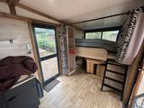 a room with a bunk bed and a desk in it