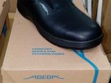 a box with a pair of black shoes on top of it