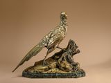 statue of a bird on a rock with a dog on it