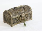 an antique brass box with a key on a white background