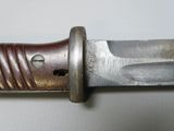 a close up of a knife on a white surface