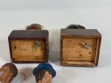 three wooden objects that are sitting on a white surface