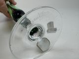 a person holding a wine glass with a bottle inside of it