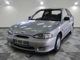 a silver car that is parked on a checkered floor