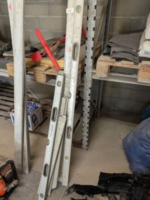 a pile of tools sitting on a shelf in a garage