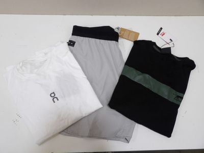 three t - shirts that are sitting on a table
