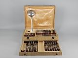 a wooden box with silverware and spoons in it