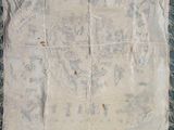 an old piece of cloth with fray edges on a blue surface