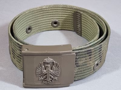 a belt with a metal buckle on it on a white surface
