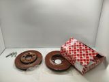 two brown brake discs are sitting in a box on a white surface