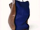 a blue and brown handbag on a white background