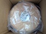 a donut wrapped in plastic sitting in a box