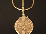 a picture of a metal hook with a bird on it