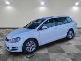a white volkswagen golf wagon parked in a garage