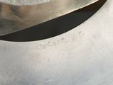 a close up of a metal object with a metal spoon in it