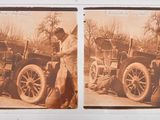 an old photo of two men working on a car in a field