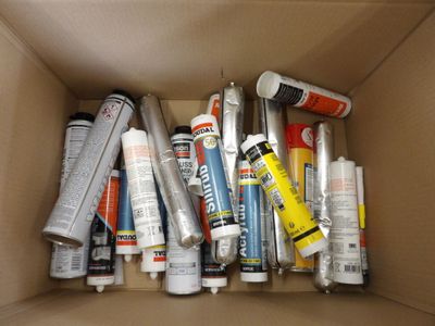 a cardboard box filled with different types of glues