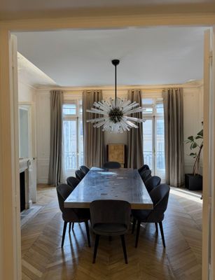 une salle à manger avec une table et des chaises et un lustre