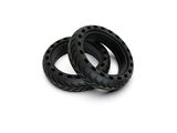 pair of black rubber rings on a white surface with a white background