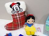 a stuffed snow white doll next to a christmas stocking