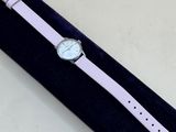 a close up of a watch in a velvet case on a table