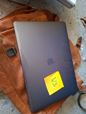 a laptop on a backpack with a sticker on it