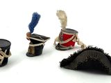three miniature hats that are sitting next to each other