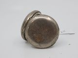 a small silver pocket watch on a white surface