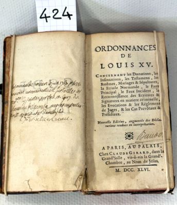 an old book with writing on it sitting on top of a table
