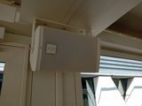 a white air conditioner hanging from the ceiling in a room