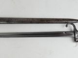 two old knives sitting on top of a table next to each other