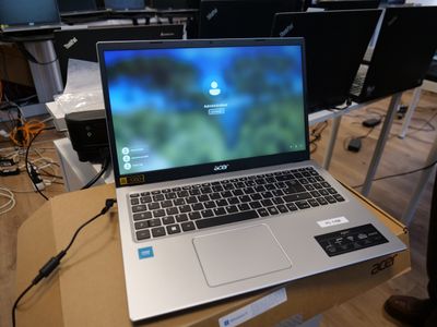 a laptop computer sitting on top of a box on a table