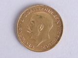 a gold coin with a picture of a man ' s face on it