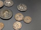 some old coins are sitting on a table with a black background