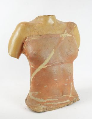 a clay sculpture of a woman ' s torso on a white background