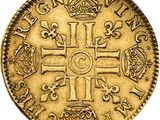 a gold coin with a cross and crown on it