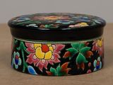 a black box with colorful flowers painted on it