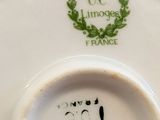 a close up of a white plate with a green design on it