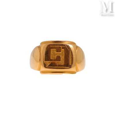 an image of a gold signet ring with the letter g on it