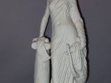 statue of a woman with a basket of flowers on a pedestal