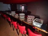 a long table with many glasses on it in a room