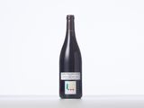 the bottle of wine is sitting on the table with a white background