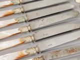 a lot of knives that are sitting on a table