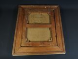 an old wooden picture frame with a picture of a man on it