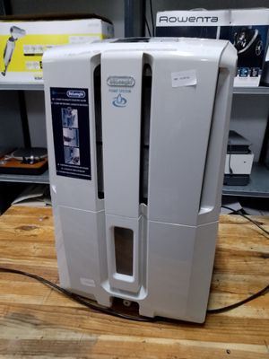 a white air purifier sitting on a wooden table