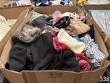a cardboard box filled with clothes and other items