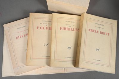 four books are stacked on top of each other on a table