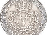 a close up of a silver coin with a crown on it