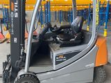 a fork lift truck that is parked in a warehouse