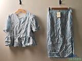 two pieces of clothing hanging on a wall next to a hanger